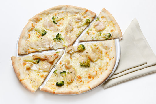 Pizza with chicken and broccoli on a white plate and on a white background