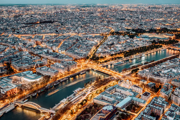 Paris city skyline rooftop view with River Seine at night, France. Evening panorama.