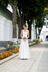 Fototapeta premium Happy smiling bride in exquisite white marriage dress.