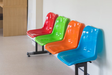 colorful plastic chairs in row for waiting room in hospital