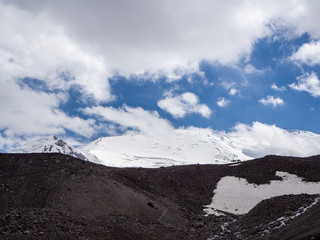 silhouettes of a rider and a horse on a background of snow-capped mountains