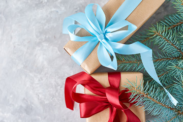 gift box with a ribbon and christmas tree branch, top view