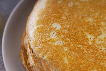Breakfast with pancakes on a textured background