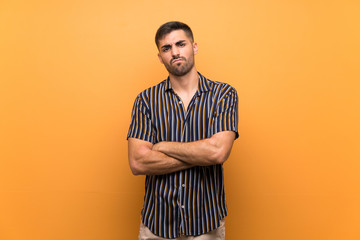 Handsome man with beard over isolated background feeling upset