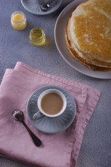 Breakfast with pancakes on a textured background