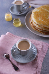 Breakfast with pancakes on a textured background