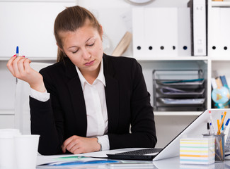 Adult woman in black suit is having complicated issue with project