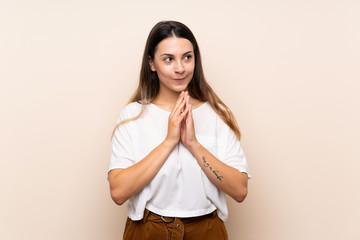 Young brunette woman over isolated background scheming something
