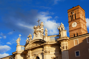 Holy Cross in Jerusalem church, wonderful late baroque masterpiece with marble statues of saints, turns to gold at sunset, in Rome (18th century)