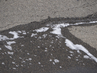 detergent foam on tarmac