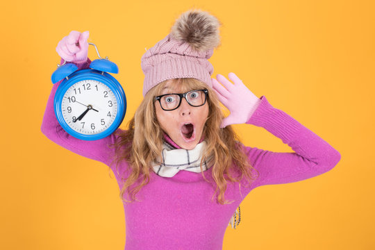 adult woman with alarm clock or alarm on color background