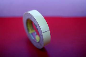 Double-sided tape isolated on red background