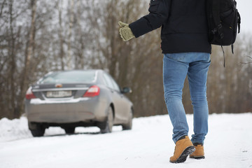 Man and car. Winter walk and car repair.