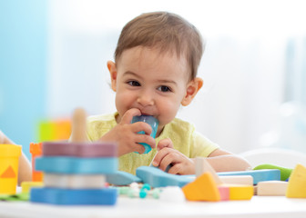Baby toddler playing with stacking learning toys