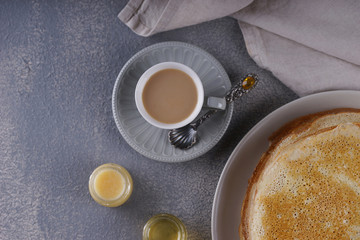 Breakfast with pancakes on a textured background