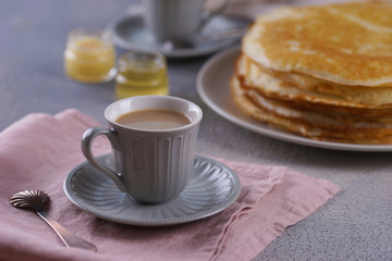 Breakfast with pancakes on a textured background