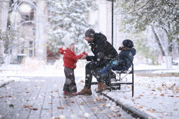 Kids walk in the park first snow
