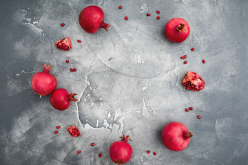 Pomegranate with seeds on dark background. Food background. Flat lay