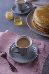 Breakfast with pancakes on a textured background
