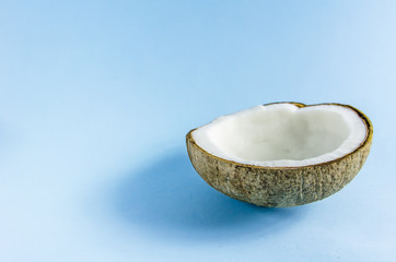 split coconut lies against a blue background
