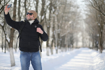 A man with a backpack frosty winter