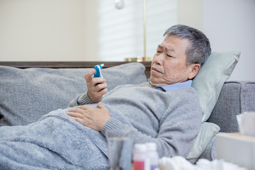 asian eldely man has a fever