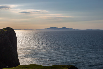 Fototapeta na wymiar Looking out to sea from Neist Point on the West of the Isle of Skye, with a view of the Outer Hebrides