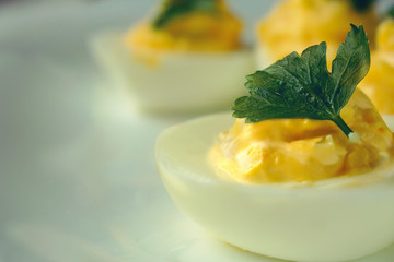 Stuffed eggs with garlic, parsley and mayonnaise  on a plate- closeup.