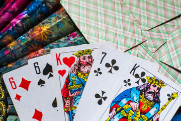 Playing cards and multi-colored fan on a blue background close-up.