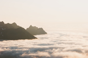 Senja island landscape in Norway mountains over clouds aerial view travel tranquil midnight scenery