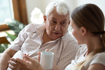 Close up focus on old man speaking with adult daughter