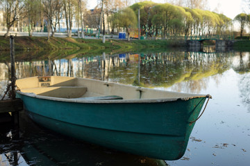 Fototapeta na wymiar plastic boat in the city pond