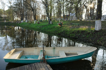 Naklejka na ściany i meble plastic boat in the city pond