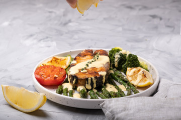Grilled salmon with asparagus, broccoli and lemon.