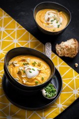 Pumpkin soup with sour cream, herbs and pumpkin seeds.