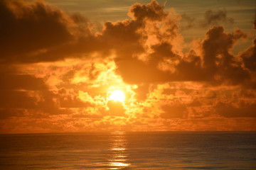Sunrise over the sea on a partly cloudy dawn