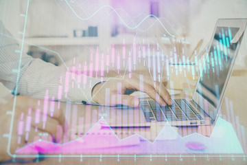 Multi exposure of stock market graph with man working on laptop on background. Concept of financial analysis.