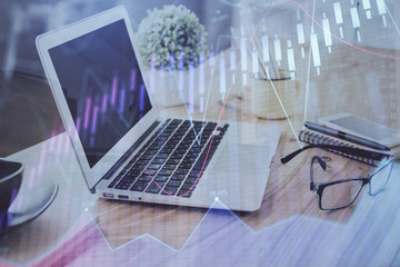 Stock market graph and table with computer background. Double exposure. Concept of financial analysis.