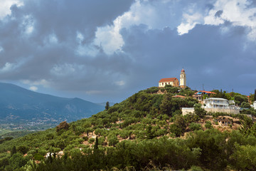 Naklejka premium Orthodox church with a bell tower on top of the hill on Zakynthos island in Greece.
