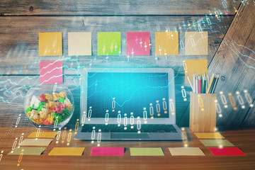 Multi exposure of chart and financial info and work space with computer background. Concept of...