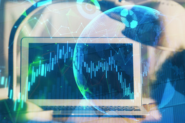 Financial graph colorful drawing and table with computer on background. Multi exposure. Concept of...