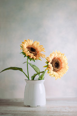 Vase of sunflowers on a wooden board copy space and vintage design