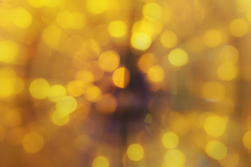 abstract defocused gold bokeh or bubble from yellow light party at night with spin circle and zoom for background and christmas festival