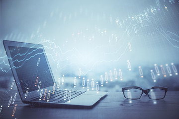 Forex graph hologram on table with computer background. Multi exposure. Concept of financial markets.