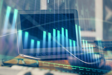 Forex graph hologram on table with computer background. Multi exposure. Concept of financial markets.