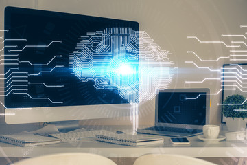 Double exposure of table with computer and brain hologram. Data innovation concept.