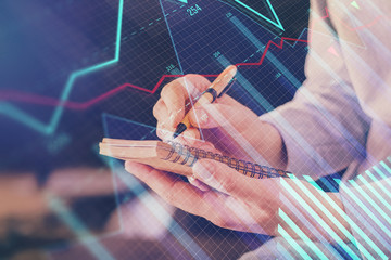 Double exposure hands with stock market chart.