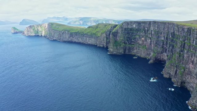 Panoramic aerial view from Sandoy island cliffs under the clouds, Faroe Islands