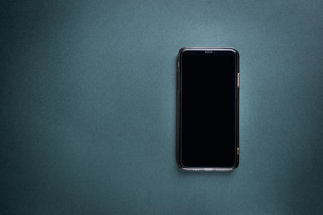 Modern Smart Phone over black background, top view