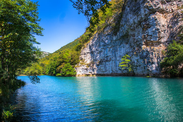 Fototapeta na wymiar Beautiful and turquoise river Una in canyon on the Croatian and Bosnia and Herzegovina border. Forest and mountains next to the river.